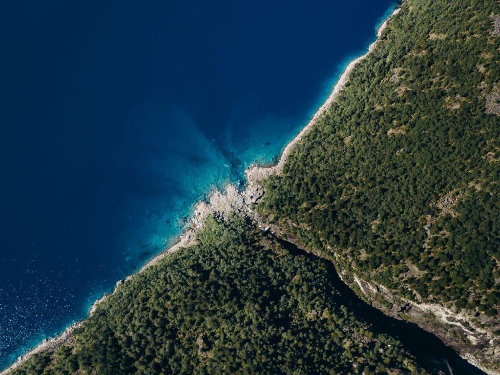 Aerial view of Papagayo Beach surrounded by cliffs