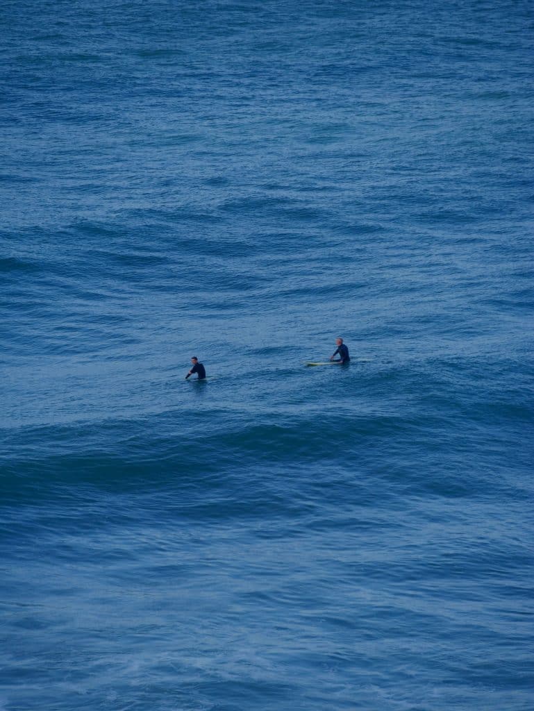 Surfers riding waves in the Atlantic Ocean
