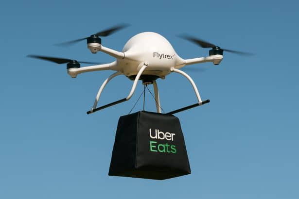 Uber Eats Flytrex delivery drone carrying food over a suburban neighborhood