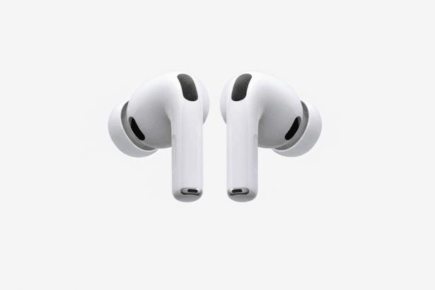A pair of white AirPods Pro earbuds with black accents, shown against a professional flat white background with soft, subtle gray gradient patterns in