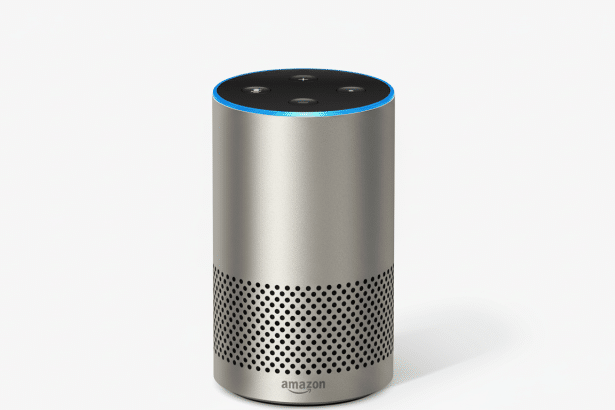 A silver Amazon Echo smart speaker with a glowing blue light ring at the top, presented on a clean white background.