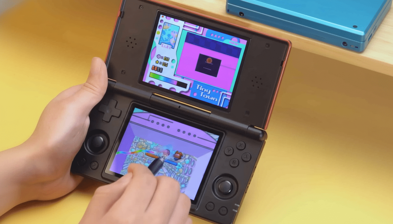 A person 's hands holding a red and black Nintendo DS console , playing a colorful game on its two screens.
