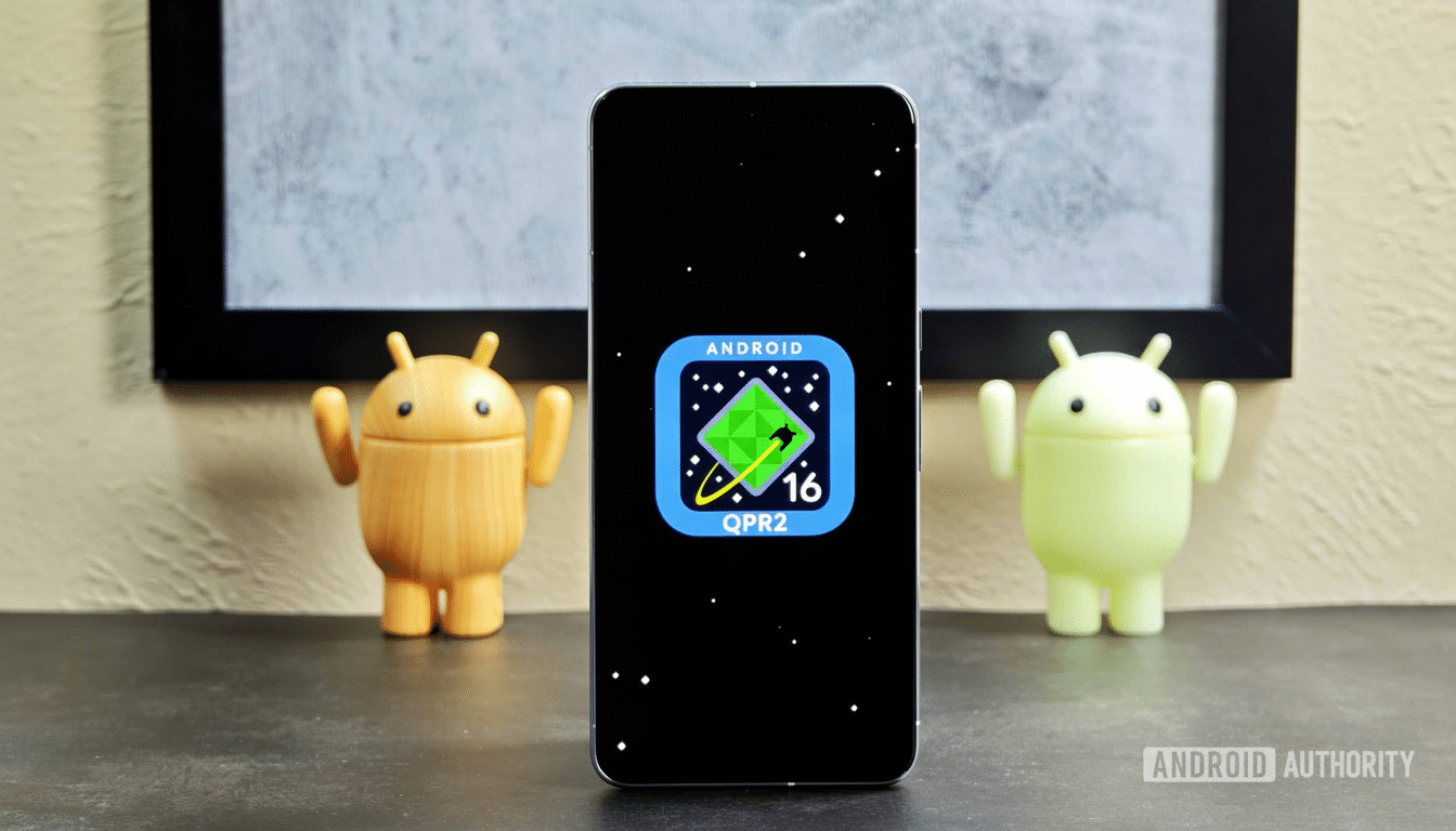 A smartphone displaying the Android 16 QPR 2 logo, with two Android figurines on either side.