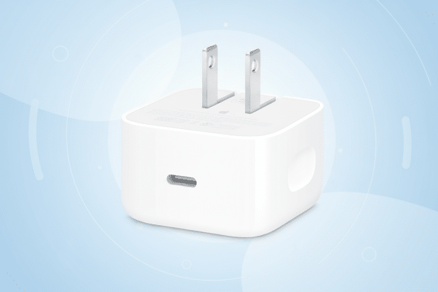 A white Apple 20 W USB-C power adapter on a professional light blue background with subtle geometric patterns, resized to a 1 6: 9 aspect ratio.