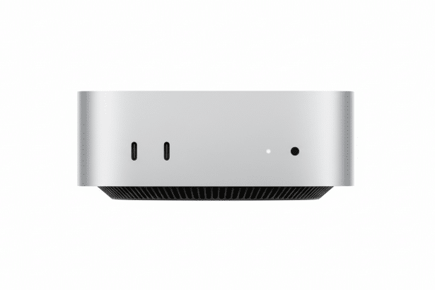 A front view of the Mac Studio desktop computer, showcasing its silver aluminum casing , two USB -C ports, power indicator light , and headphone jack , presented on a white background with a 16:9 aspect ratio.