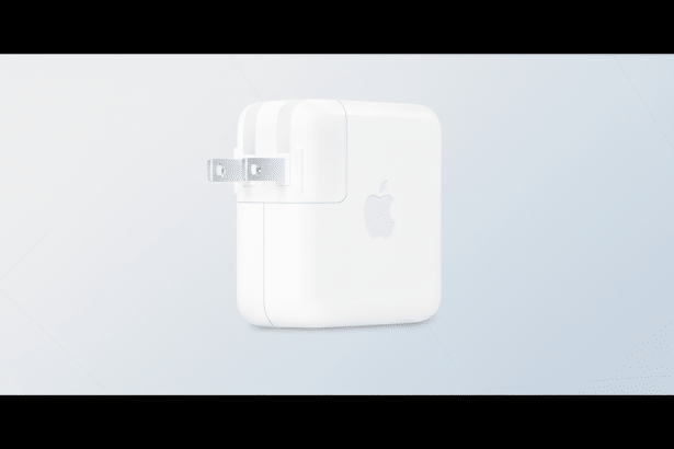 A white Apple power adapter with a two -pronged plug, set against a professional light blue and white gradient background with subtle geometric patterns. Filename : applepower adapterprofessional .png