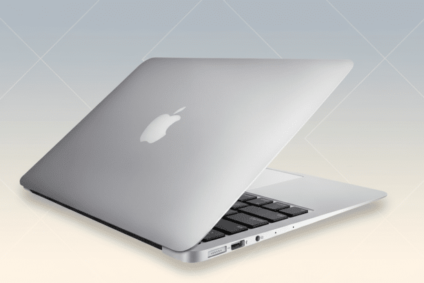 A silver MacBook Air laptop, seen from a slightly elevated angle with the lid partially open, on a soft gradient background with subtle geometric patt