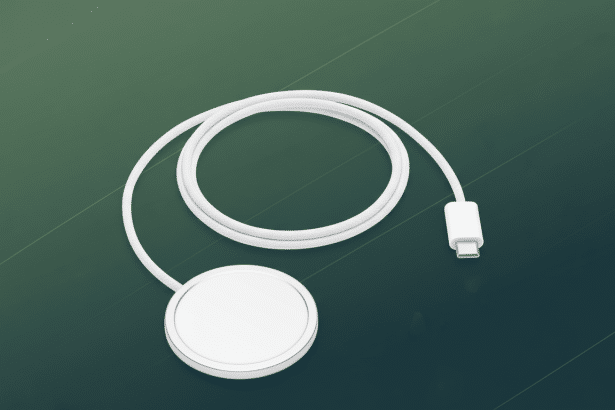 A white MagSafe charger with a USB- C connector on a professional dark green background with subtle diagonal line patterns. Filename : magsafe charger16 x 9. png