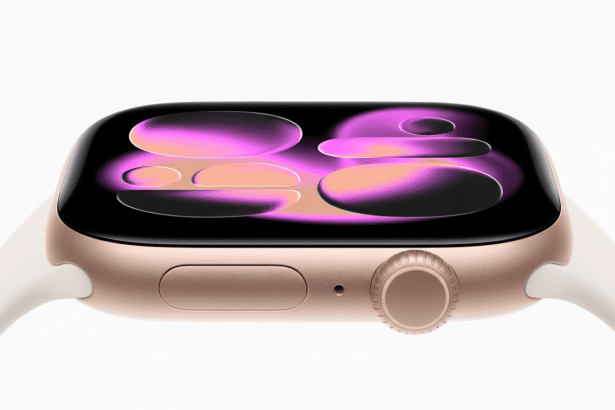 Close -up of a gold Apple Watch with a white band, displaying a colorful, abstract watch face.