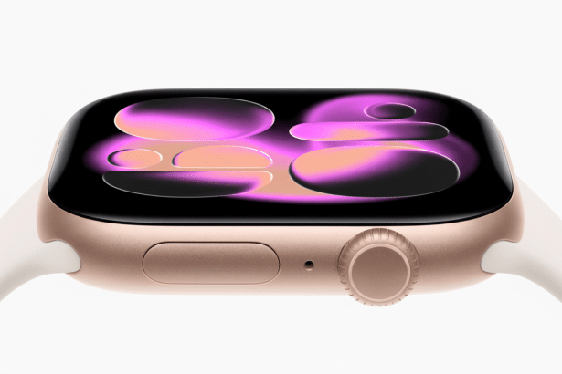 A close -up, side view of a gold- colored Apple Watch with a white band, displaying a vibrant abstract pink and orange watch face on a white backgroun