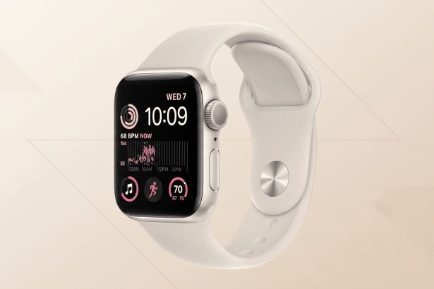 An Apple Watch SE with a cream-colored band and a black screen displaying the time, heart rate , and activity metrics .