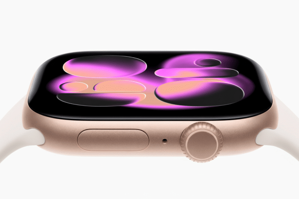 Close -up of a gold Apple Watch with a white band, displaying abstract purple and orange shapes on its screen, set against a clean white background.