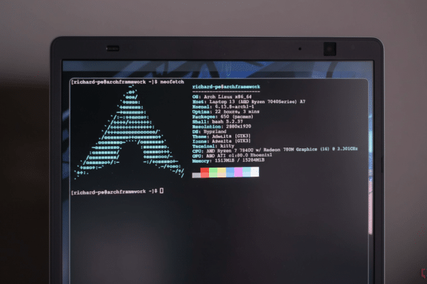A laptop screen displaying a terminal window running `neofetch `, showing system information for an Arch Linux installation with an AMD Ryzen 7 processor and Radeon 780M Graphics .