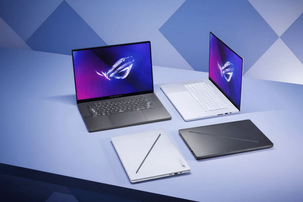 A collection of four Asus ROG Ze phyrus G 14 and G16 laptops in dark grey and white, arranged on a blue surface with a geometric background. Filename : as usrog zephyrus laptops.png