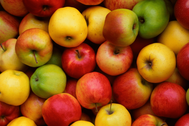 A vibrant and diverse assortment of red , yellow, and green apples, filling the frame in a professional and appealing arrangement. Filename : assorted applesprofessional .png