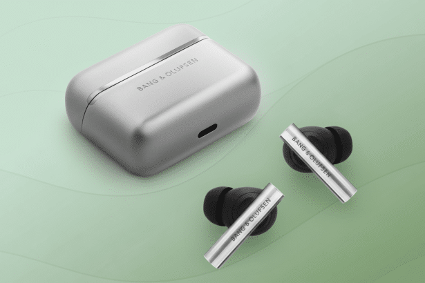 Bang & Olufsen wireless earbuds and their charging case, presented on a subtle green background with a soft wave pattern.