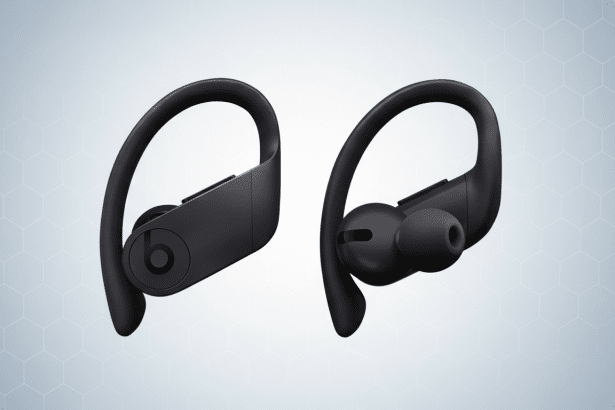 A pair of black Beats Powerbeats Pro wireless earbuds with ear hooks, displayed against a light grey background with subtle hexagonal patterns .