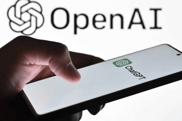 A hand holding a smartphone displaying the ChatGPT logo , with the OpenAI logo visible in the blurred background. Filename : openaichat gptphone . png