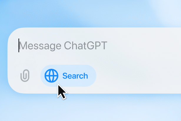text : A close-up of a message input field with Message ChatGPT typed in grey , a paper clip icon