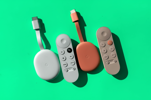 A top -down shot of two Google Chromecast devices and their corresponding remotes on a vibrant green background. The devices are white and coral, with the remotes featuring white and grey buttons.