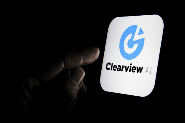 The Clear view AI logo displayed on a smartphone screen, with a finger pointing towards it, against a dark background.