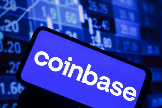 A smartphone displaying the Coinbase logo against a background of stock market data.