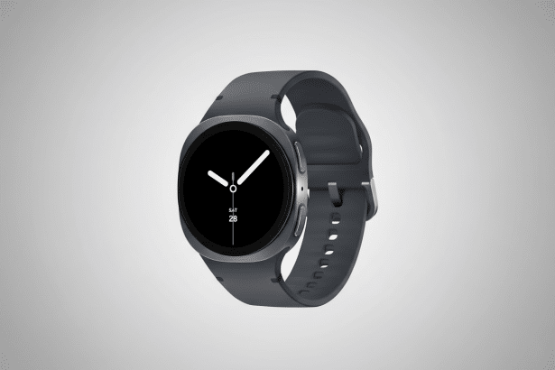 A professional shot of a dark gray smartwatch with a black circular display showing the time and date ( SAT 28 ), set against a clean, light gray grad