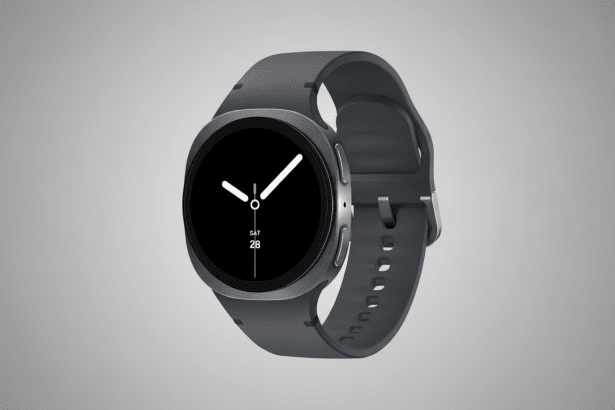 A professional shot of a dark gray smartwatch with a black circular display showing the time and date ( SAT 28 ). The watch is angled slightly, with its strap visible, against a subtle gray gradient background. Filename : dark graysmart watchprofessional .png