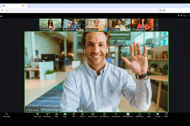 A professional man waves during a video call interface, surrounded by other participants.