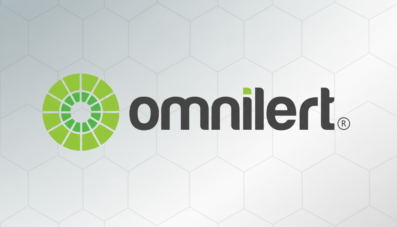 The Omnilert logo, featuring a green circular icon composed of segmented shapes resembling an eye or target, next to the word omnilert in dark gray lowercase letters with a lighter green dot over the i, all set against a subtle gray hexagonal pattern background.