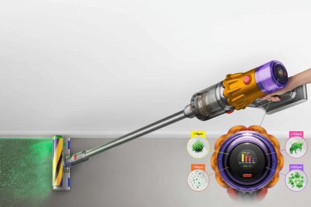 A professional 16: 9 image of a Dyson Gen 5 detect vacuum cleaner in action, with a hand holding the device. The vacuum head illuminates dust particle