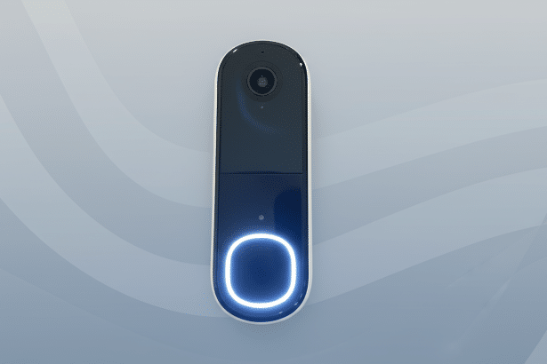 A modern smart doorbell with a camera and a glowing blue button, presented on a subtle gray background with soft , flowing wave patterns, resized to a 1 6:9 aspect ratio. Filename : smartdoor bell16 x 9. png