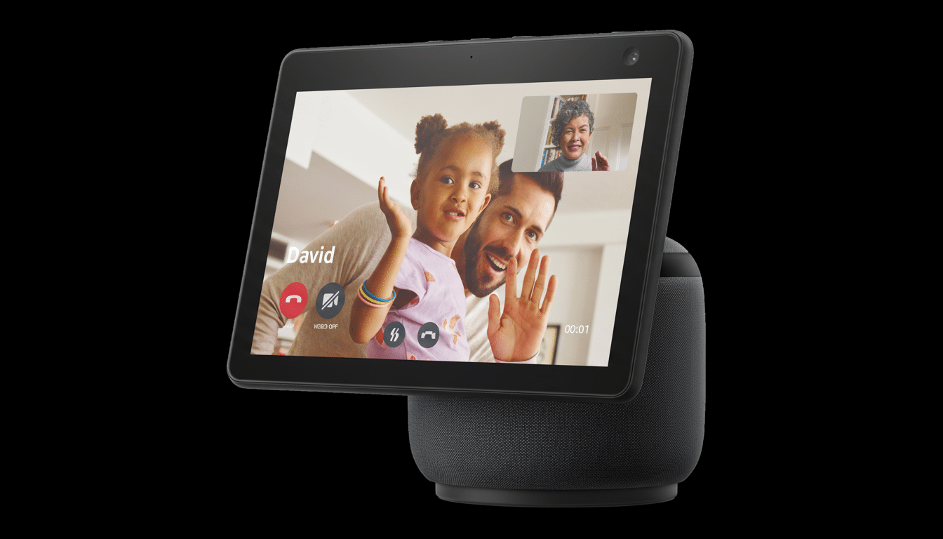 An Amazon Echo Show 1 0 displaying a video call with a man and a young girl waving, and a smaller inset of an older woman. The device is black with a
