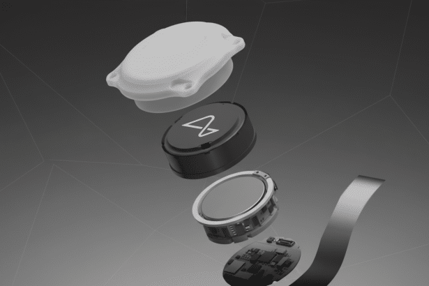 An exploded view of a small, round electronic device, showing its components including a white top cover, a black body with a white stylized A logo, an internal metallic disc, and a circuit board, all arranged against a professional grey background with subtle geometric patterns. Filename : explodedview electronic device.png