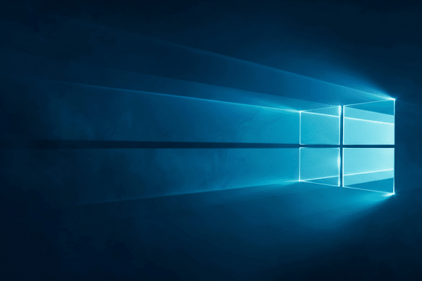 alt text: The Windows 10 logo, a four-pane window icon glowing bright blue against a dark blue, s