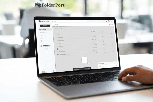 A professional image of a Folder Port application on a laptop screen, with a person 's hand typing on the keyboard. The background features a blurred modern office setting.