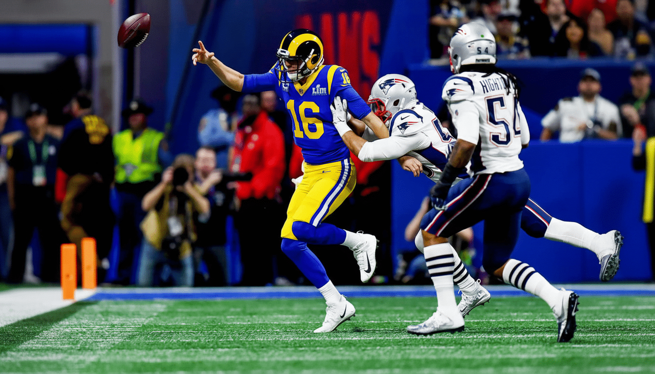 An American football player in a blue and yellow uniform, number 16, ev ades a tackle from two opposing players in white uniforms on a green football