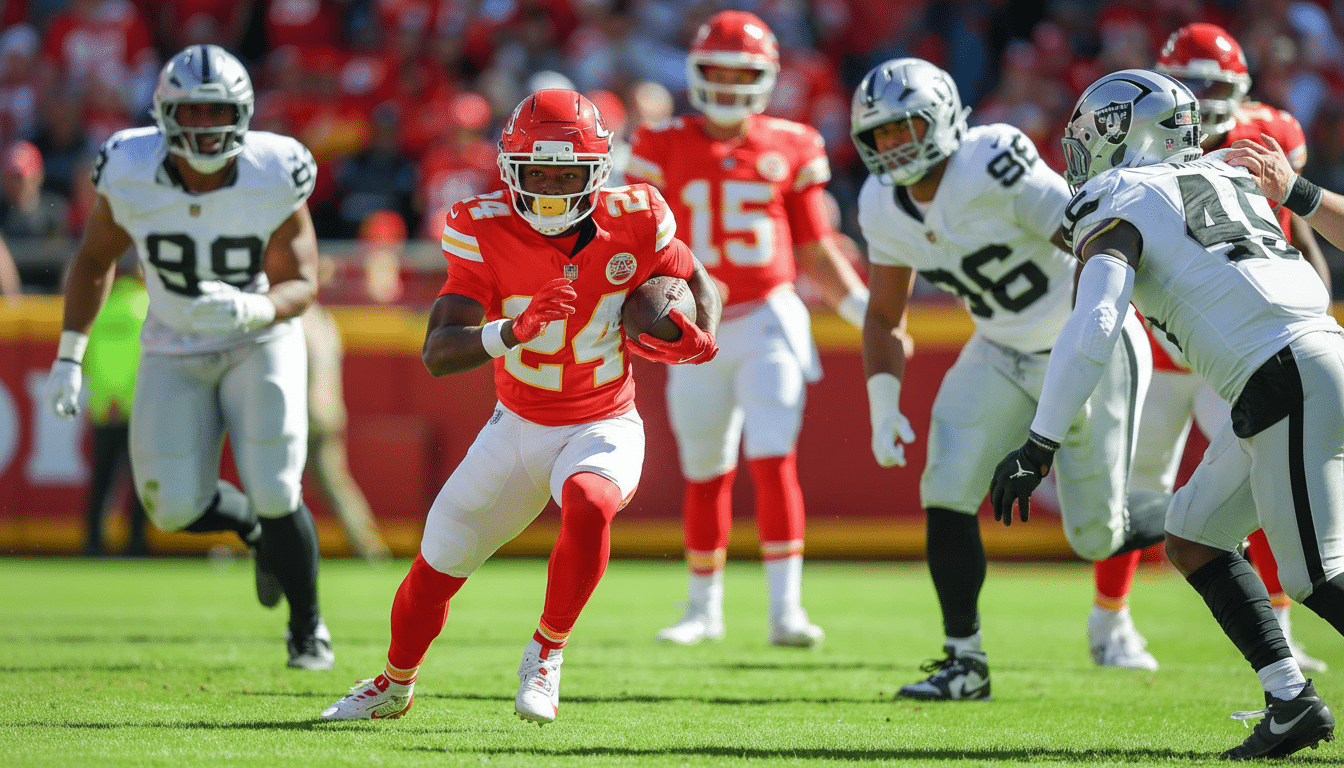 A professional American football player in a red jersey with the number 2 4, running with the ball on a green field during a game.