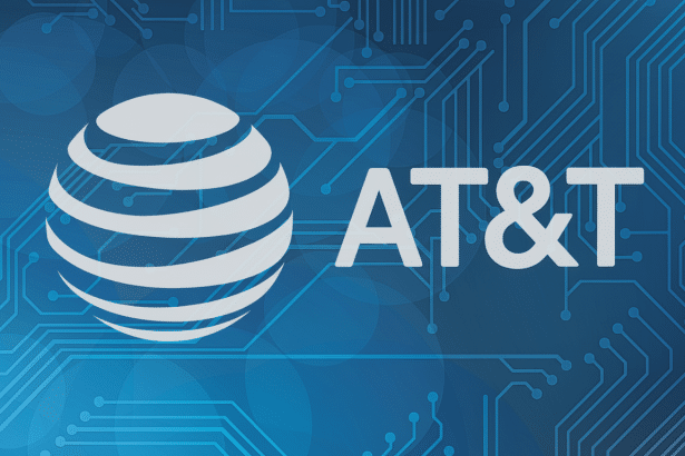 The AT&T logo , featuring a white globe icon and the text AT&T, against a blue background with a subtle circuit board pattern and soft bokeh- like circles .