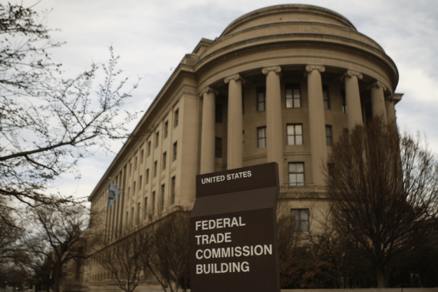 The Federal Trade Commission Building in Washington D.C., with a sign in the foreground.