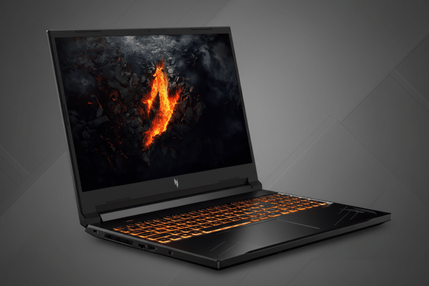 A professional shot of a black gaming laptop with orange backlit keys and a volcanic- themed desktop background.