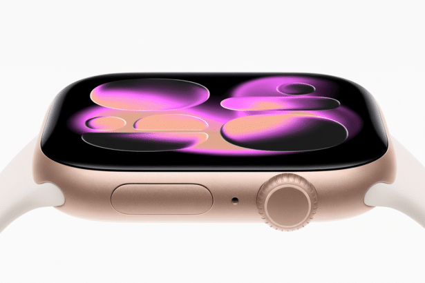 A gold Apple Watch with a white band, displaying a vibrant pink and purple abstract watch face, set against a clean white background.