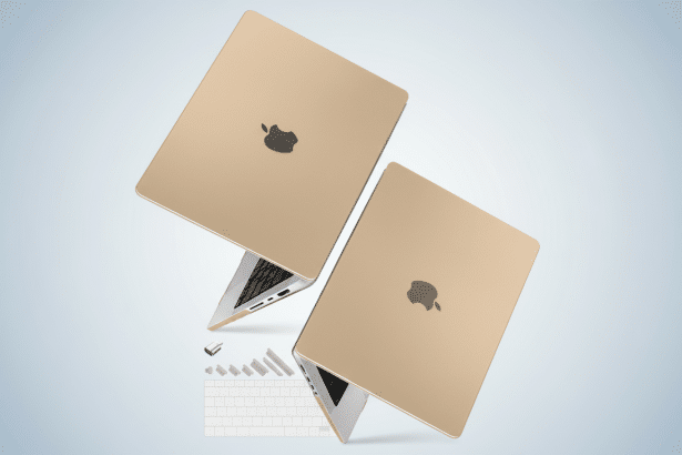 Two golden laptops with the Apple logo on the back, shown at an angle against a light blue gradient background with subtle abstract shapes. Filename : goldenl aptopsprofessional .png