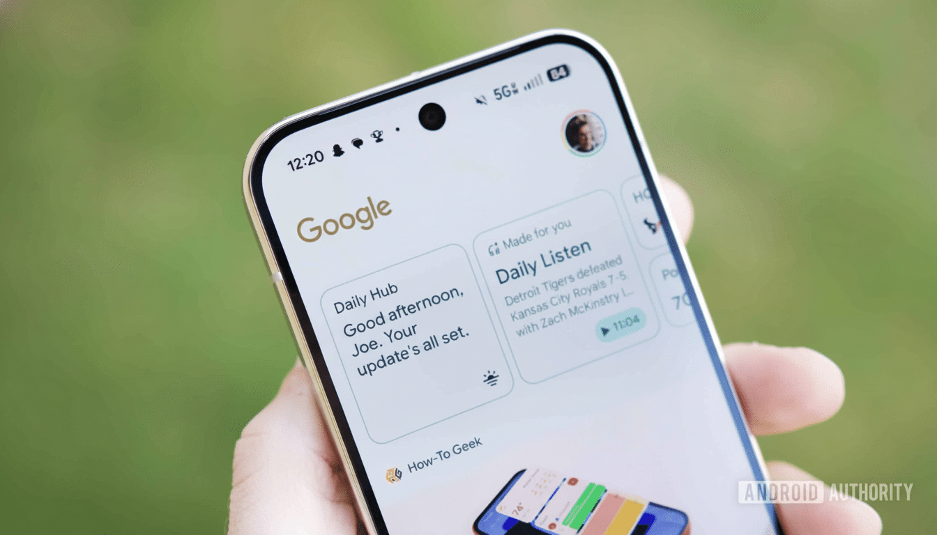 A hand holding a smartphone displaying the Google app with a news feed and daily updates.