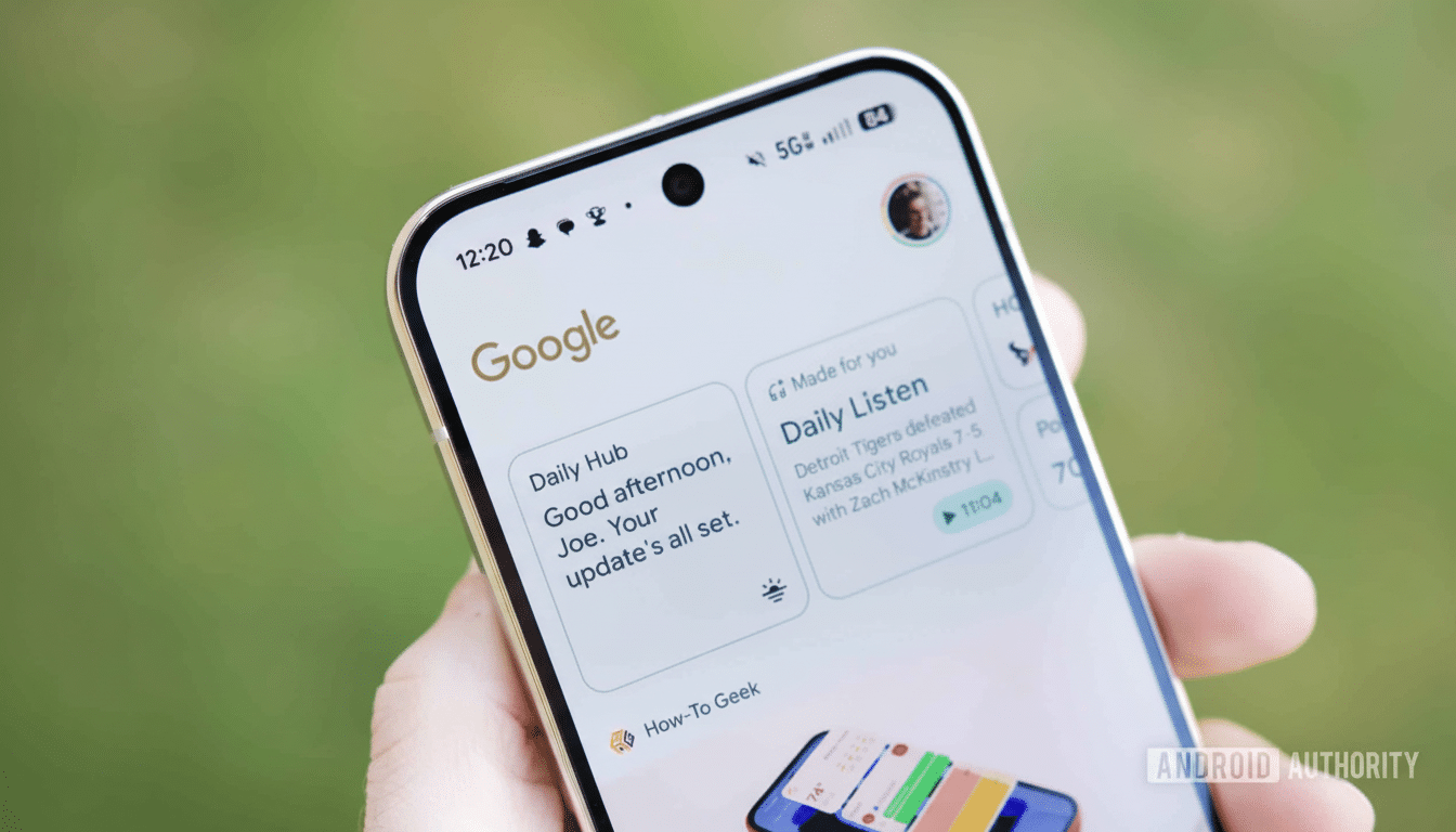 A hand holding a smartphone displaying the Google app with a news feed and daily updates.