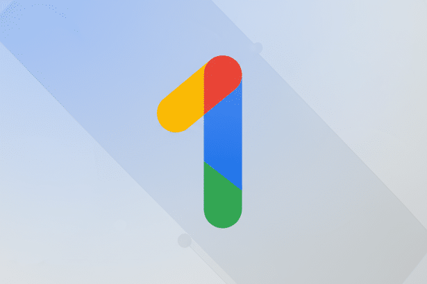 The Google One logo, a stylized number 1 in red , yellow, blue , and green, centered on a professional flat design background with soft light blue and gray geometric patterns.