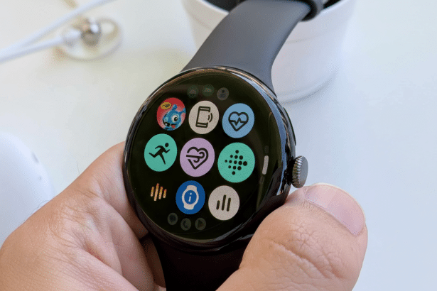 A hand holding a Google Pixel Watch displaying a grid of colorful app icons on its screen , with a black band visible .