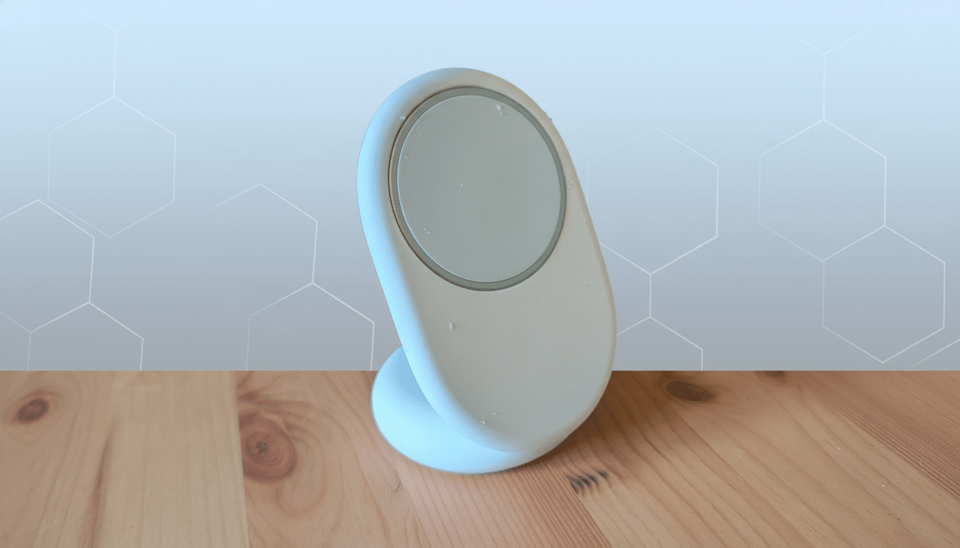 A white , oval -shaped wireless charger with a grey circular charging pad, sitting on a wooden surface with a soft blue and grey geometric background. Filename : wirelesscharger professional . png