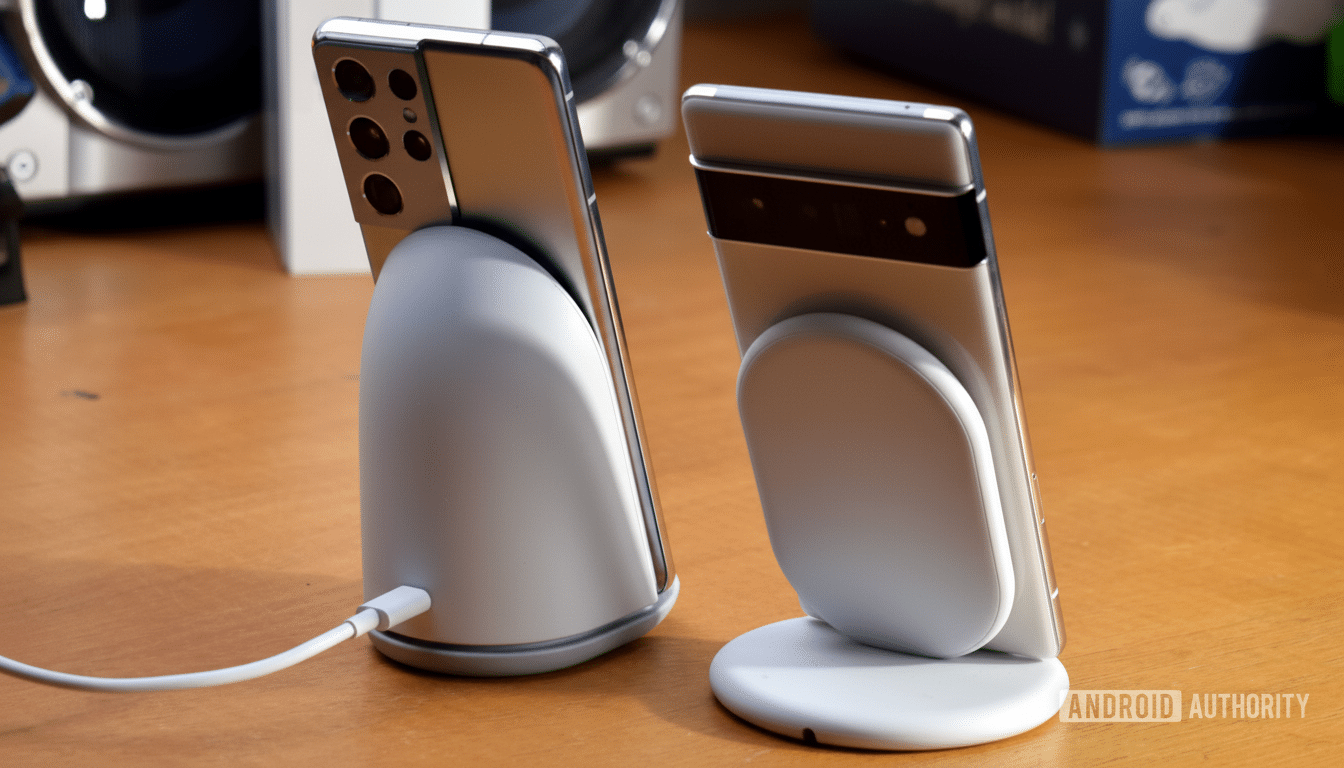 alt  text= Two smartphones on white wireless charging stands, one with a visible charging cable, o