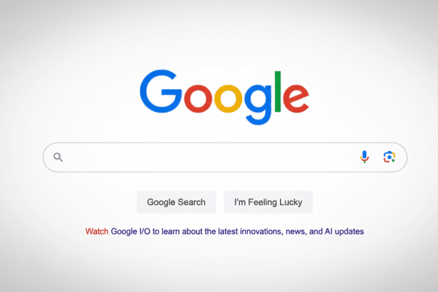 Google search homepage with a prominent search bar and logo, text at the bottom says Watch Google I /O to learn about the latest innovations, news, an